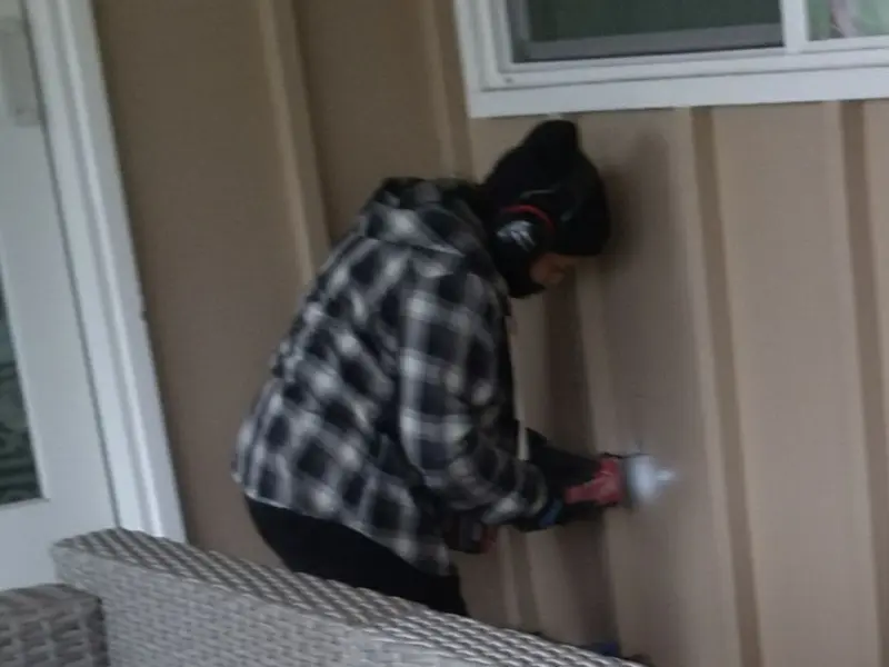 Professional electrician installing an exterior outlet in Athol